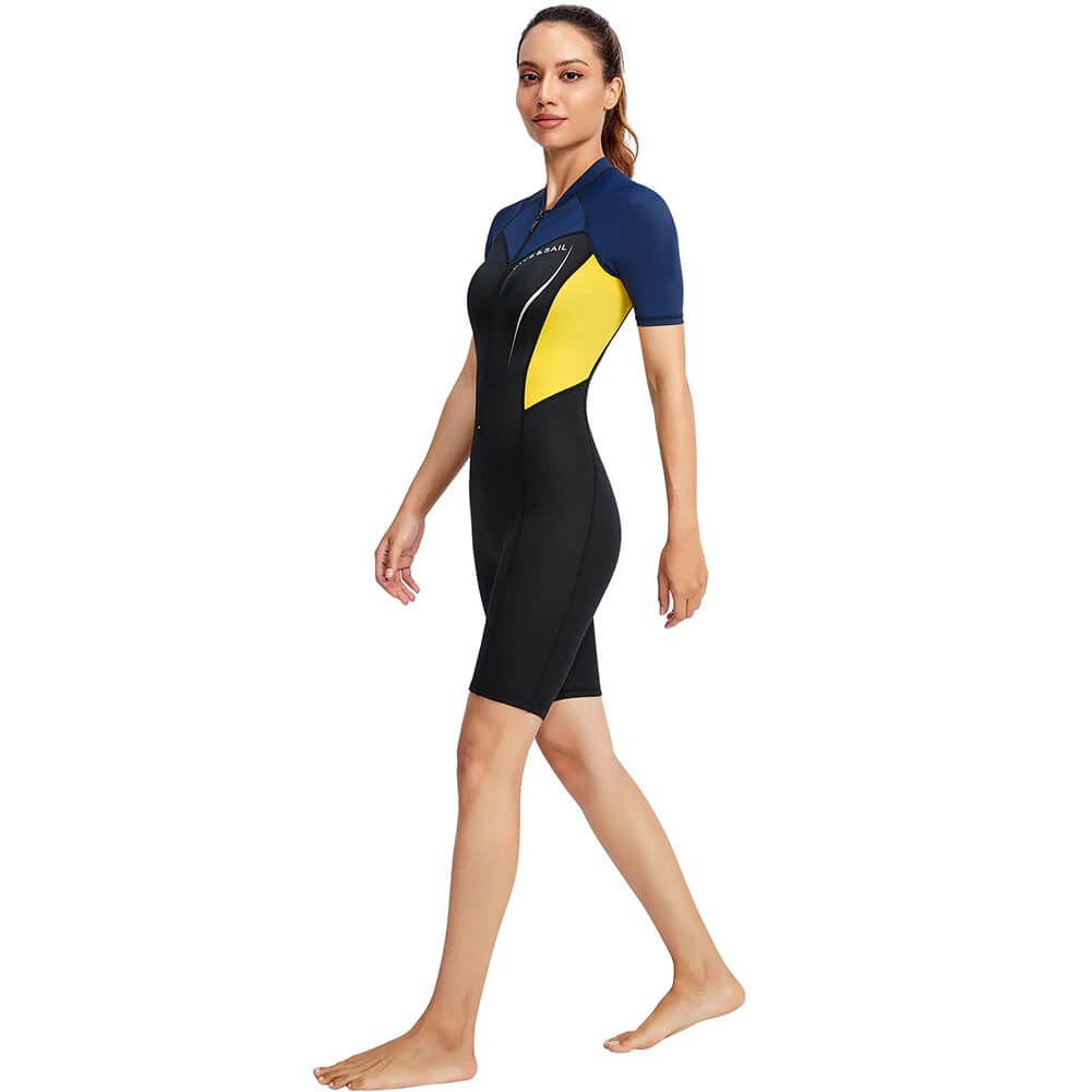 Female model wearing a Women's 1.5mm neoprene wetsuit for surfing and diving, featuring a mix of black, yellow, and blue colors.